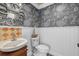 Quaint powder room showcases unique wallpaper, elegant mirror, and stylish fixtures at 4715 Spinnaker Dr, Bradenton, FL 34208