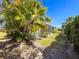 An expansive backyard with a screened lanai and neatly trimmed shrubs at 4729 Peridia E Blvd, Bradenton, FL 34203