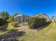A spacious backyard featuring well-maintained landscaping and a screened lanai at 4729 Peridia E Blvd, Bradenton, FL 34203