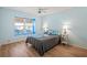 Bedroom featuring wood floors, blue walls, and lots of natural light at 4729 Peridia E Blvd, Bradenton, FL 34203