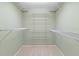 Walk-in closet with multiple shelves for optimal storage and organization at 4729 Peridia E Blvd, Bradenton, FL 34203