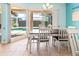 Comfortable dining area with a view of the screened-in lanai and swimming pool at 4729 Peridia E Blvd, Bradenton, FL 34203