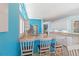 Bright eat-in kitchen featuring a breakfast bar, stainless steel appliances, and blue walls with natural light at 4729 Peridia E Blvd, Bradenton, FL 34203
