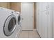 Laundry room with washer and dryer, tile floor and built-in storage at 4729 Peridia E Blvd, Bradenton, FL 34203