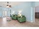 Bright living area with tile floors and comfortable green sofas at 4729 Peridia E Blvd, Bradenton, FL 34203