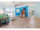 Open living room with tile floors, blue accent wall, and sliding glass doors to the pool at 4729 Peridia E Blvd, Bradenton, FL 34203