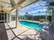 Sparkling screened-in pool with brick paver patio and multiple ceiling fans for outdoor enjoyment at 4729 Peridia E Blvd, Bradenton, FL 34203