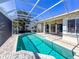 Beautiful screened-in pool with clear blue water and a spacious brick patio, ideal for entertaining at 4729 Peridia E Blvd, Bradenton, FL 34203