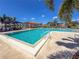 Sparkling pool featuring clear water, ample seating, and shaded dining area at 4729 Peridia E Blvd, Bradenton, FL 34203