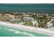 Stunning aerial view of beachfront condos, pool, and the Gulf of Mexico's turquoise waters at 4835 Gulf Of Mexico Dr # 106, Longboat Key, FL 34228