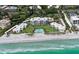 Panoramic aerial view showcases well-maintained condos, lawn, pool, and beach access at 4835 Gulf Of Mexico Dr # 106, Longboat Key, FL 34228