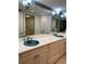 Elegant bathroom with double sinks, custom palm tree-themed basins, and modern fixtures at 4835 Gulf Of Mexico Dr # 106, Longboat Key, FL 34228