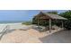 Relaxing beach lounge area with shaded seating, chairs, and Gulf views at 4835 Gulf Of Mexico Dr # 106, Longboat Key, FL 34228