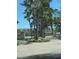 Circular brick driveway with mature landscaping and palm trees at 4835 Gulf Of Mexico Dr # 106, Longboat Key, FL 34228