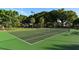 Well-maintained tennis court with lush green surface, ready for a friendly match at 4835 Gulf Of Mexico Dr # 106, Longboat Key, FL 34228