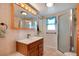 Tiled bathroom featuring a vanity, mirror, shower, and toilet at 517 Tampico Dr, North Port, FL 34287