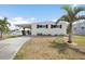 Charming single-story home featuring a covered carport and well-maintained landscaping at 517 Tampico Dr, North Port, FL 34287