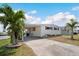 Well-maintained manufactured home features a covered carport and neatly landscaped front yard at 517 Tampico Dr, North Port, FL 34287