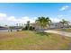 Waterfront manufactured home showcases lush lawn and a private dock in a serene setting at 517 Tampico Dr, North Port, FL 34287