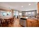 Open-concept kitchen with stainless steel appliances and breakfast table overlooking the canal at 517 Tampico Dr, North Port, FL 34287