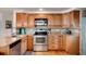 Well-equipped kitchen featuring granite countertops, stainless steel appliances, and wood cabinets at 517 Tampico Dr, North Port, FL 34287