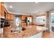 Bright kitchen with granite countertops, stainless steel appliances, and a convenient breakfast bar at 517 Tampico Dr, North Port, FL 34287