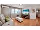 Modern living room featuring a sleek couch, decorative fireplace and scenic wall-mounted television at 517 Tampico Dr, North Port, FL 34287