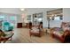 Comfortable living space with warm wood floors and cozy rattan furniture, perfect for relaxing at 517 Tampico Dr, North Port, FL 34287