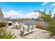 Waterfront patio featuring a dining table, chairs, grill, and outdoor seating at 517 Tampico Dr, North Port, FL 34287