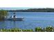 Boat with anglers on the water offers recreational opportunities in a scenic, natural setting at 517 Tampico Dr, North Port, FL 34287