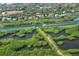 Stunning aerial shot showcasing the community's waterfront location, surrounding greenery, and nearby waterways at 5230 Landings Blvd # 101, Sarasota, FL 34231
