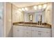 Bathroom with double vanity, granite countertop, large mirror, and ample lighting at 5230 Landings Blvd # 101, Sarasota, FL 34231