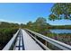 Picturesque boardwalk offering a scenic pathway through lush mangroves and a serene waterfront view at 5230 Landings Blvd # 101, Sarasota, FL 34231