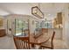 Dining room with view of screened in patio and open concept kitchen at 5230 Landings Blvd # 101, Sarasota, FL 34231