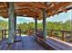 Charming wooden gazebo with seating, nestled amongst lush greenery, providing a tranquil outdoor retreat at 5230 Landings Blvd # 101, Sarasota, FL 34231