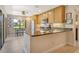 Bright kitchen with stainless steel appliances and a breakfast bar area at 5230 Landings Blvd # 101, Sarasota, FL 34231