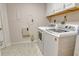 Laundry room with white washer and dryer, and white cabinets at 5230 Landings Blvd # 101, Sarasota, FL 34231