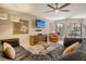 Bright living room with large windows, a comfortable leather couch, and ceiling fan at 5230 Landings Blvd # 101, Sarasota, FL 34231