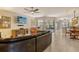 Spacious living area featuring a ceiling fan, tile flooring, and access to the outdoor patio at 5230 Landings Blvd # 101, Sarasota, FL 34231