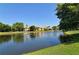 Scenic pond view with fountains surrounded by lush greenery and trees, offering a peaceful community setting at 5230 Landings Blvd # 101, Sarasota, FL 34231