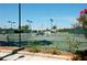 Well-maintained community tennis courts with lighting and covered benches for players and spectators at 5230 Landings Blvd # 101, Sarasota, FL 34231