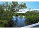 Calm water view reflecting the sky, framed by lush green mangroves at 5230 Landings Blvd # 101, Sarasota, FL 34231