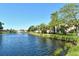 Scenic water view featuring the building's exterior, lush lawn and a tranquil fountain at 5230 Landings Blvd # 101, Sarasota, FL 34231