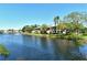 Scenic water view featuring the building's exterior, lush lawn and a tranquil fountain at 5230 Landings Blvd # 101, Sarasota, FL 34231