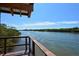 Tranquil water view from a wooden deck with railings overlooking river and trees at 5230 Landings Blvd # 101, Sarasota, FL 34231