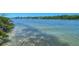 Scenic water view with clear, shallow water and lush mangroves along the shoreline, perfect for nature enthusiasts at 5230 Landings Blvd # 101, Sarasota, FL 34231