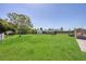 Wide backyard with green grass, a shed, and a fire pit with an adjacent back deck at 5231 32Nd E St, Bradenton, FL 34203