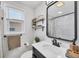 Bright bathroom featuring a modern vanity, decorative shelving, and a stylish mirror at 5231 32Nd E St, Bradenton, FL 34203