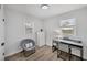 Cozy bedroom featuring two windows, a comfortable chair, and a functional desk at 5231 32Nd E St, Bradenton, FL 34203