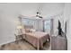 Bedroom featuring a ceiling fan, neutral decor, and a cozy reading chair by the window at 5231 32Nd E St, Bradenton, FL 34203
